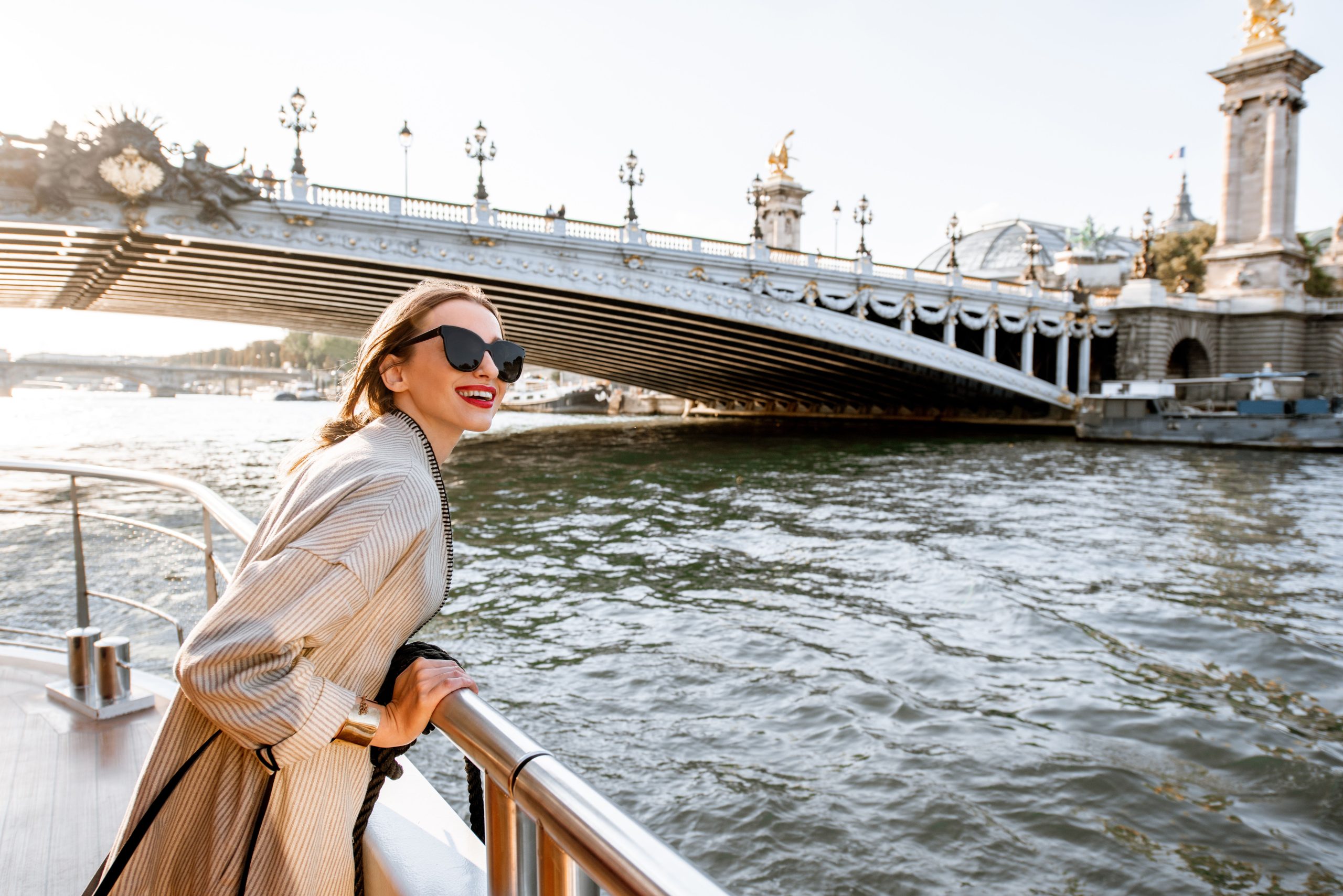 Woman's elegant beige coat with sunglasses in Paris